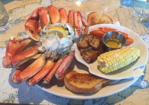 A Platter Of Food Including Corn And Seafood